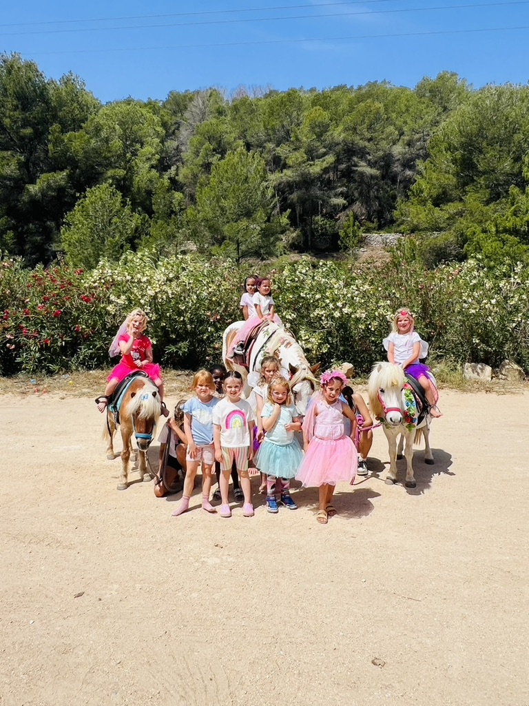 Group of children with decorated ponies at a Paradise Stables party